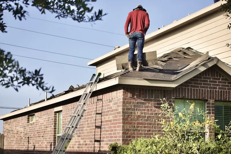 Professional roofer working on a residential roof in Sharper